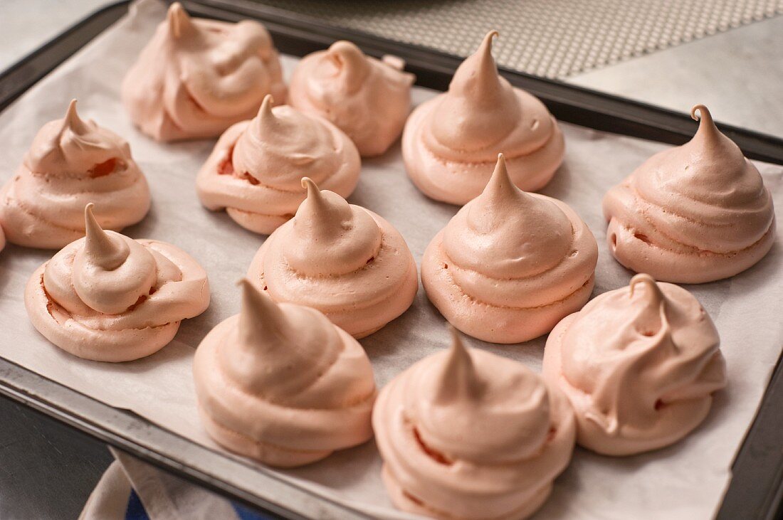 Homemade pink meringues on a small baking dish