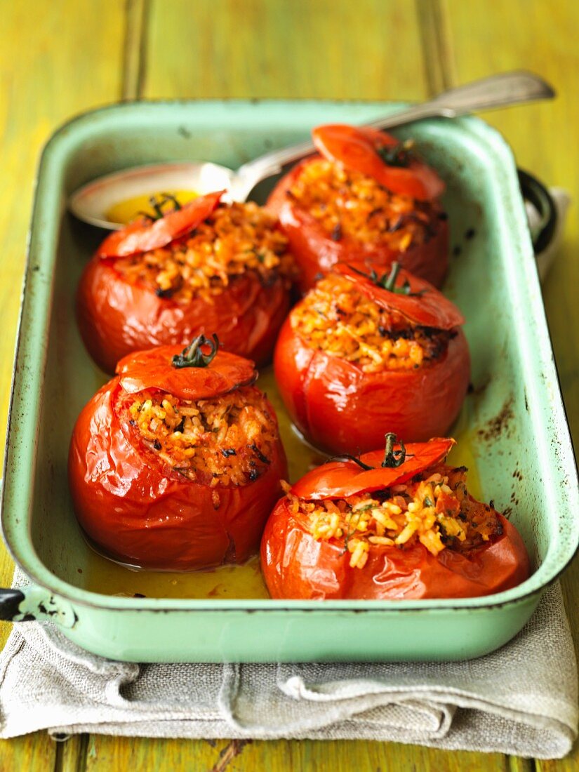 Stuffed tomatoes in an enamel baking dish