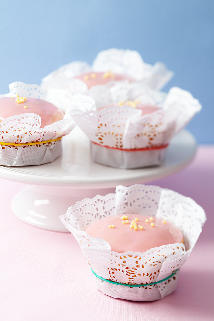 Muffins in doilies on a cake stand