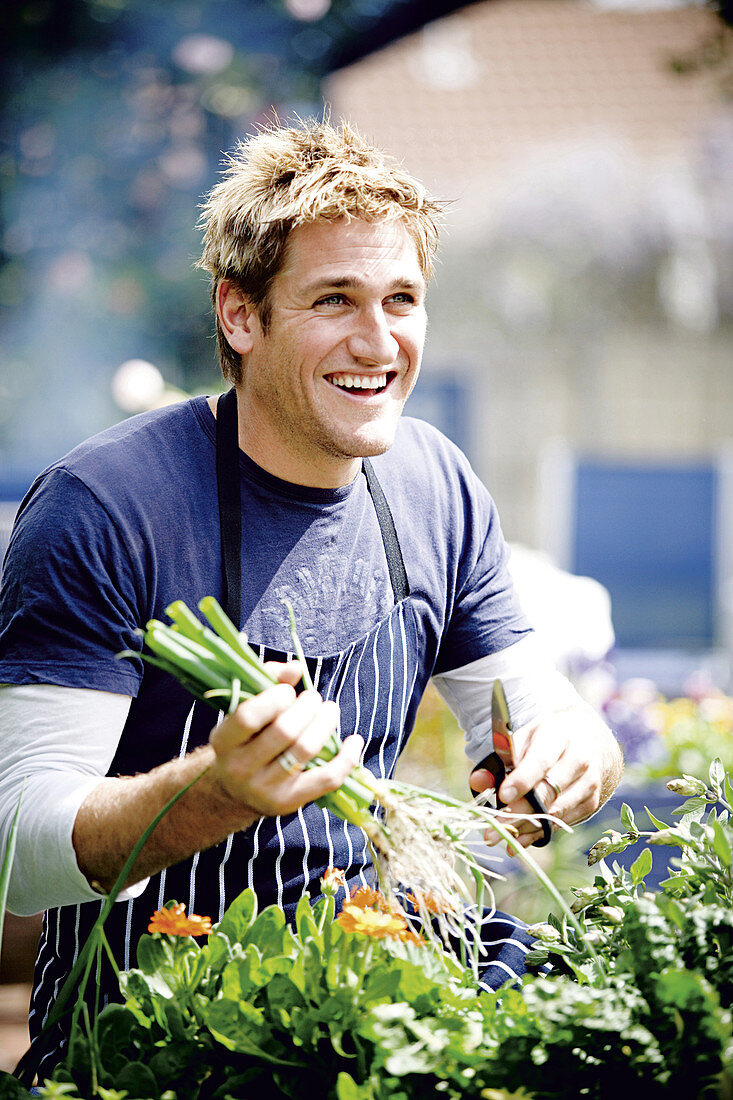 A chef with fresh garden vegetables