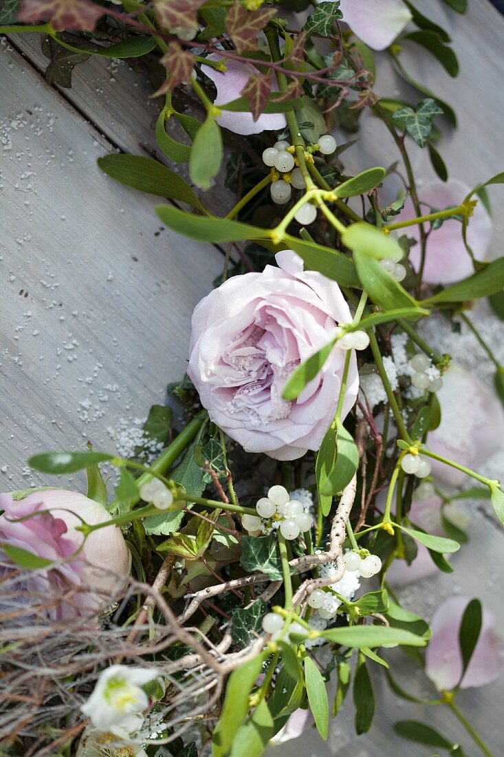 A wreath of pink roses and mistletoe