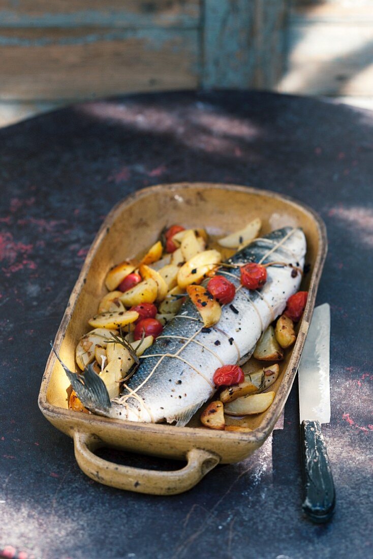 Stuffed bass with rosemary potatoes and cocktail tomatoes