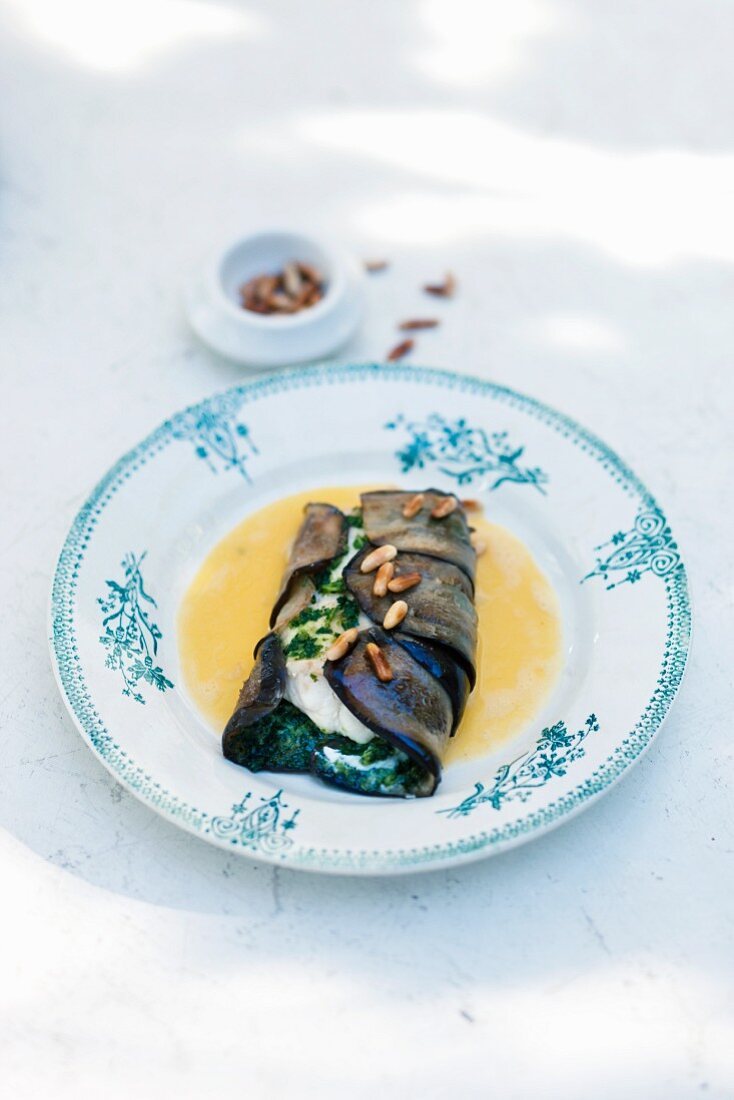 Wolffish with basil puree wrapped in aubergine