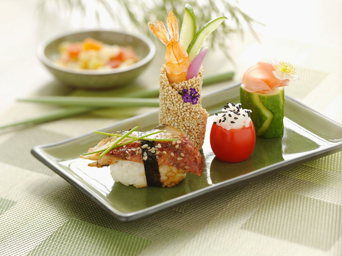 Assorted Sushi on a Green Plate; Chopsticks