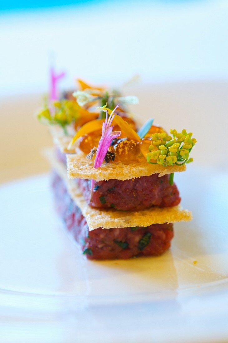 American Kobe Beef Tartare with Gilded Wild Salmon Roe, Basil Blossoms and Arugula Flowers