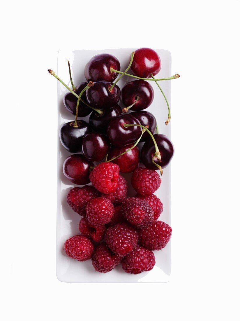 Fresh raspberries and cherries on a serving platter