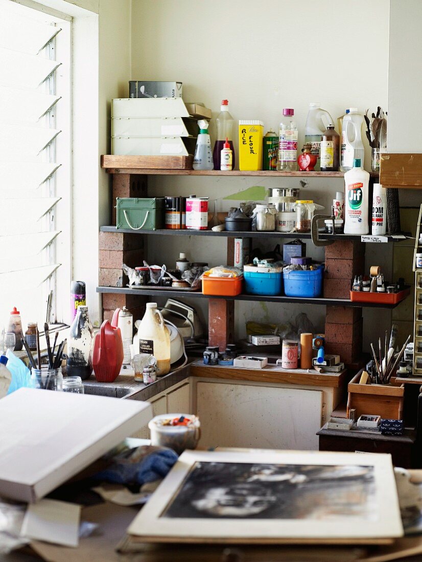 Shelves of painting utensils in work area