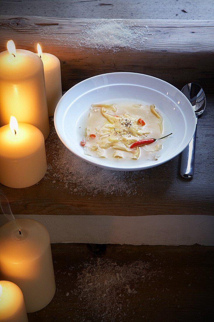 Broth with cauliflower ravioli and chilli peppers for Christmas