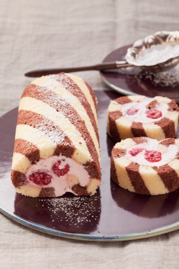 Black and white sponge roll with a raspberry filling