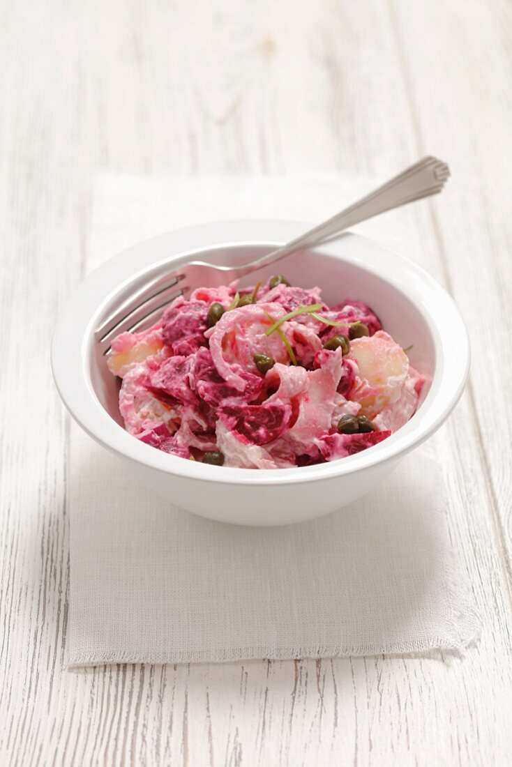 Potato and beetroot salad with ham, onion and a horseradish dressing