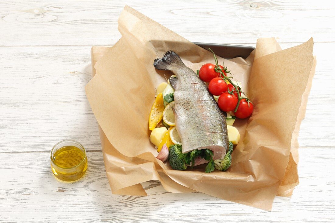 Stuffed trout with vegetables in foil (raw)