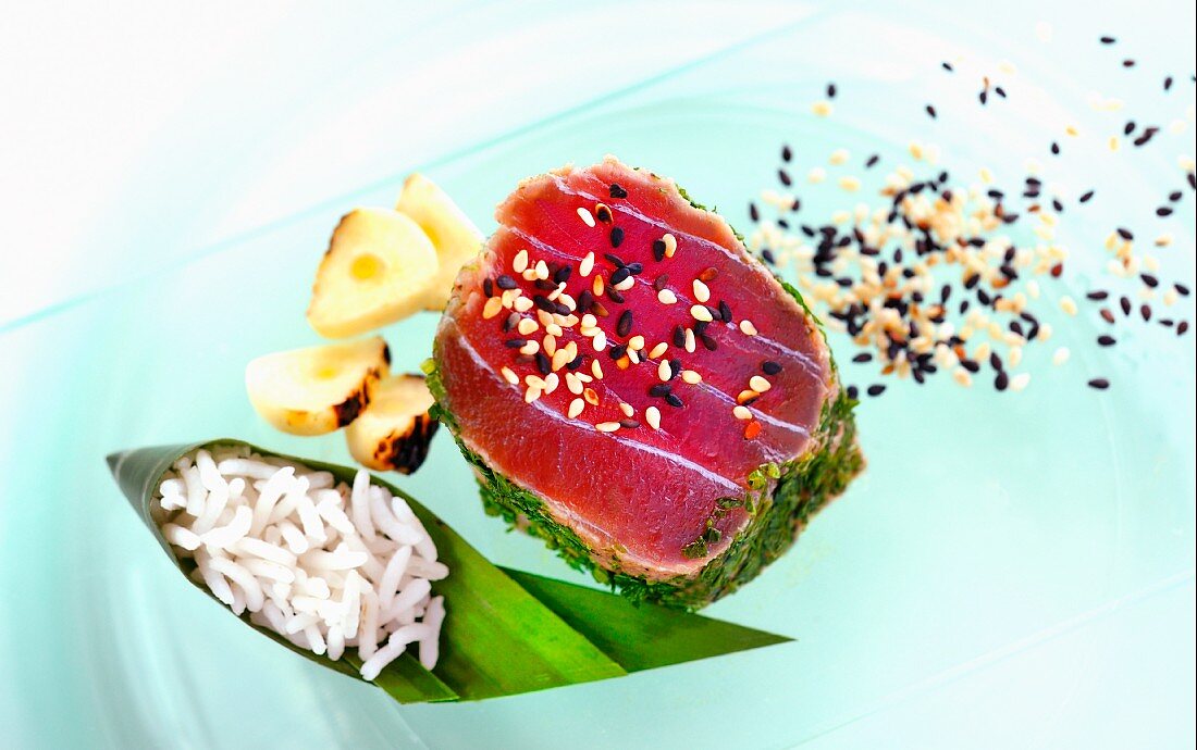 Tuna fillet with a herb crust, sesame seeds and a side of rice (Asia)
