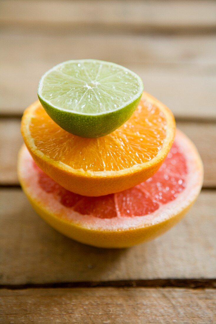 Half a grapefruit, half an orange and half a lime, stacked