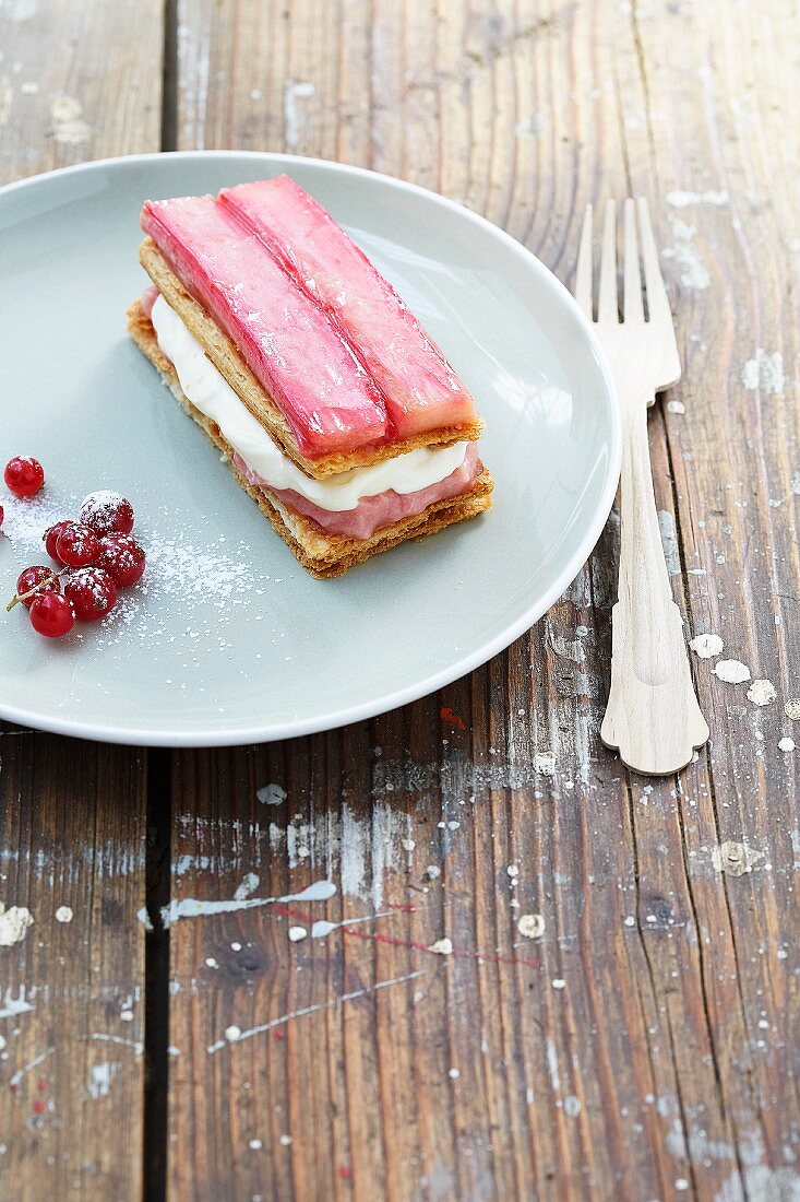 A slice of rhubarb cream cake with red currants