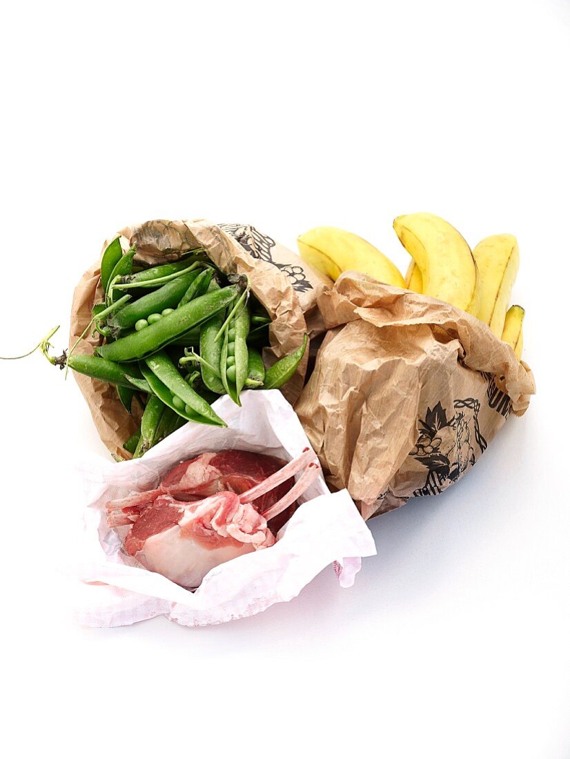 Lamb chops, bananas and pea pods in a paper bag