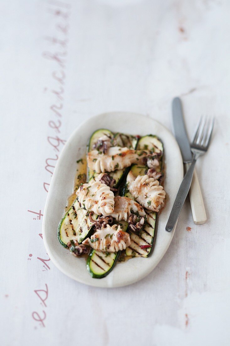 Calamaretti on a bed of grilled courgettes