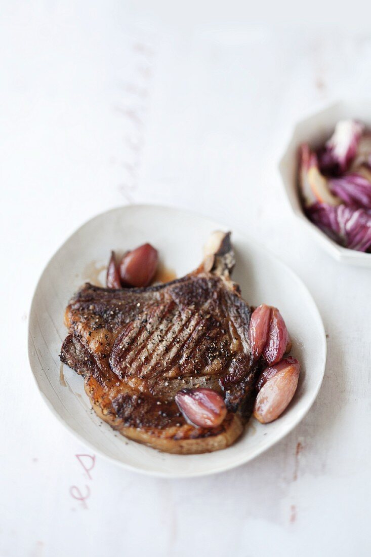 Veal chop with chilli shallots and a radicchio and pear salad