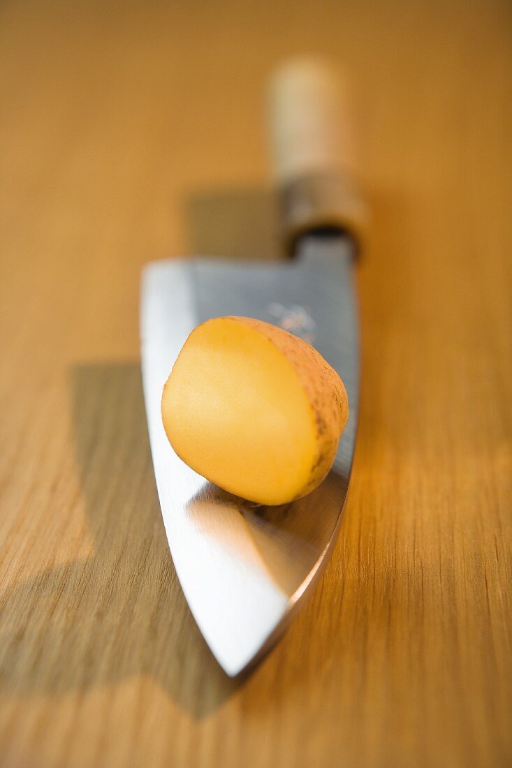 Half a potato on a knife