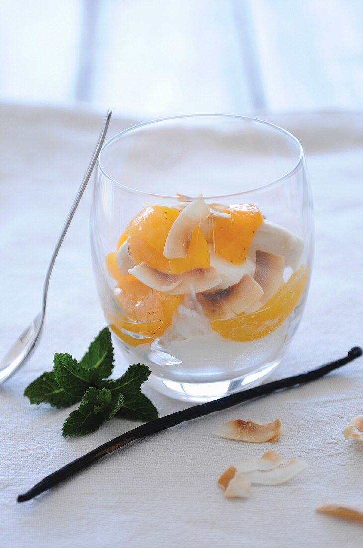 Poached peaches with roasted coconut chips and coconut ice cream