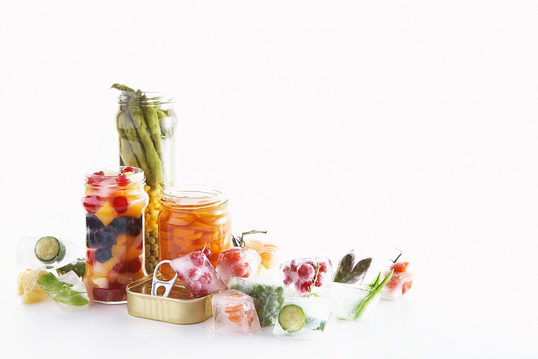 Pickled vegetables and fruit, pickling jars and ice cubes