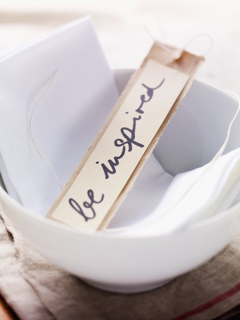 A label with the words 'be inspired' written on it in a bowl