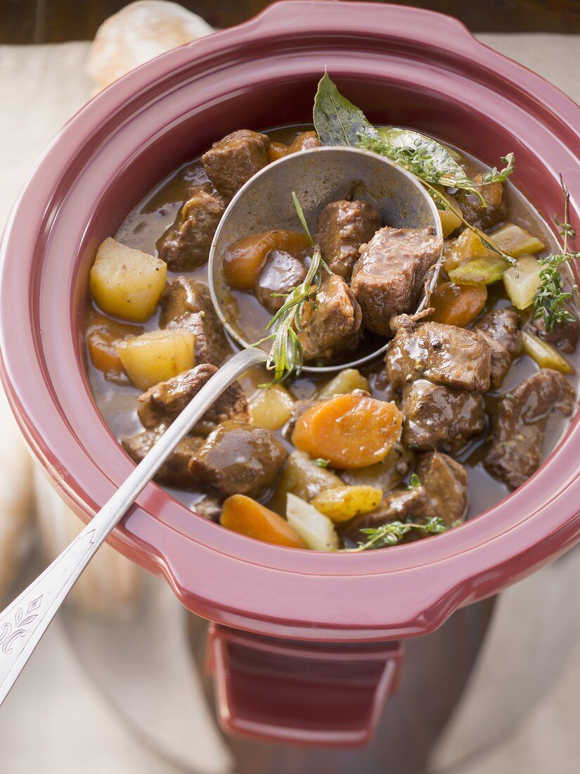 Beef stew being made in a slow cooker