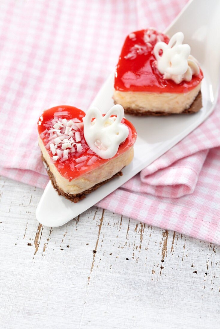 Two heart-shaped cream cakes on the cake slice