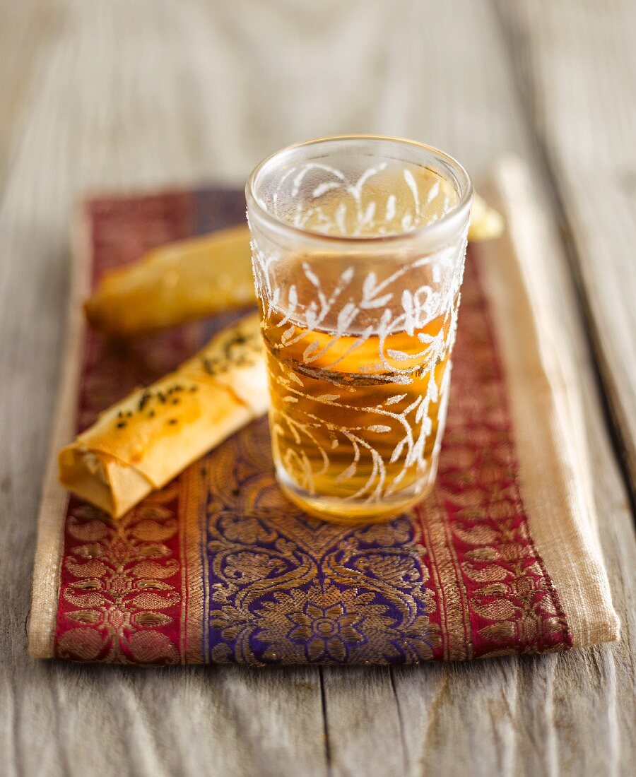 Black tea in a glass with yufka dough rolls (Orient)