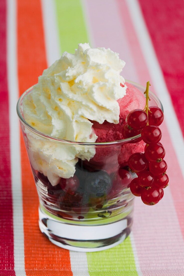 Cream and berries in a glass