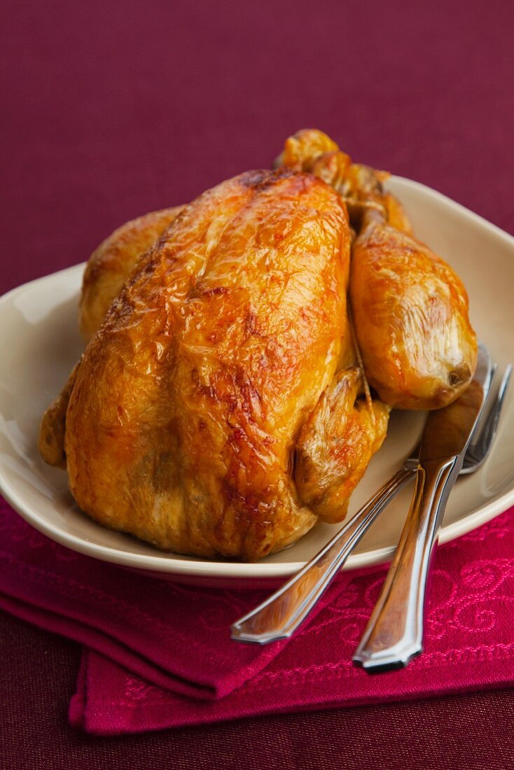 A whole roast chicken on a serving platter