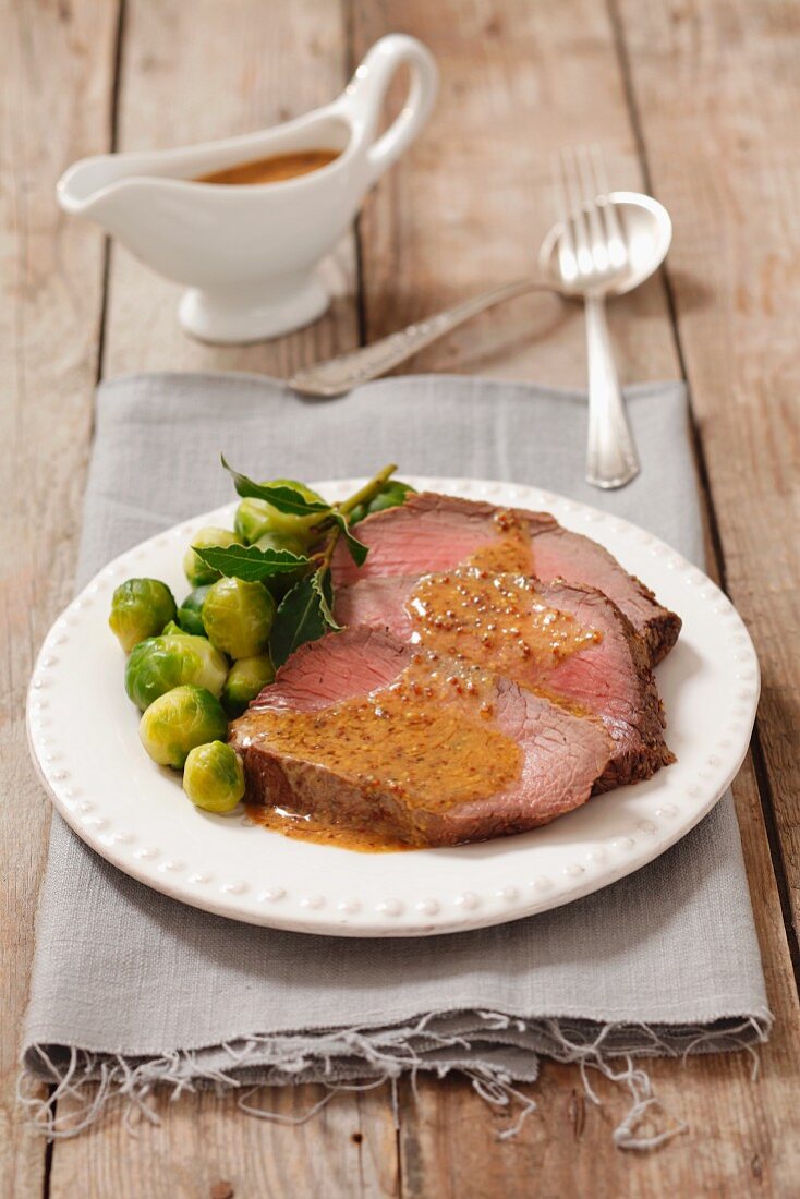 Roast beef with mustard sauce and Brussels sprouts