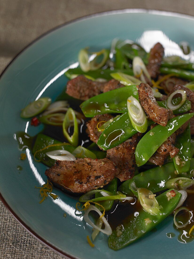 Duck breast with mange tout and spring onions