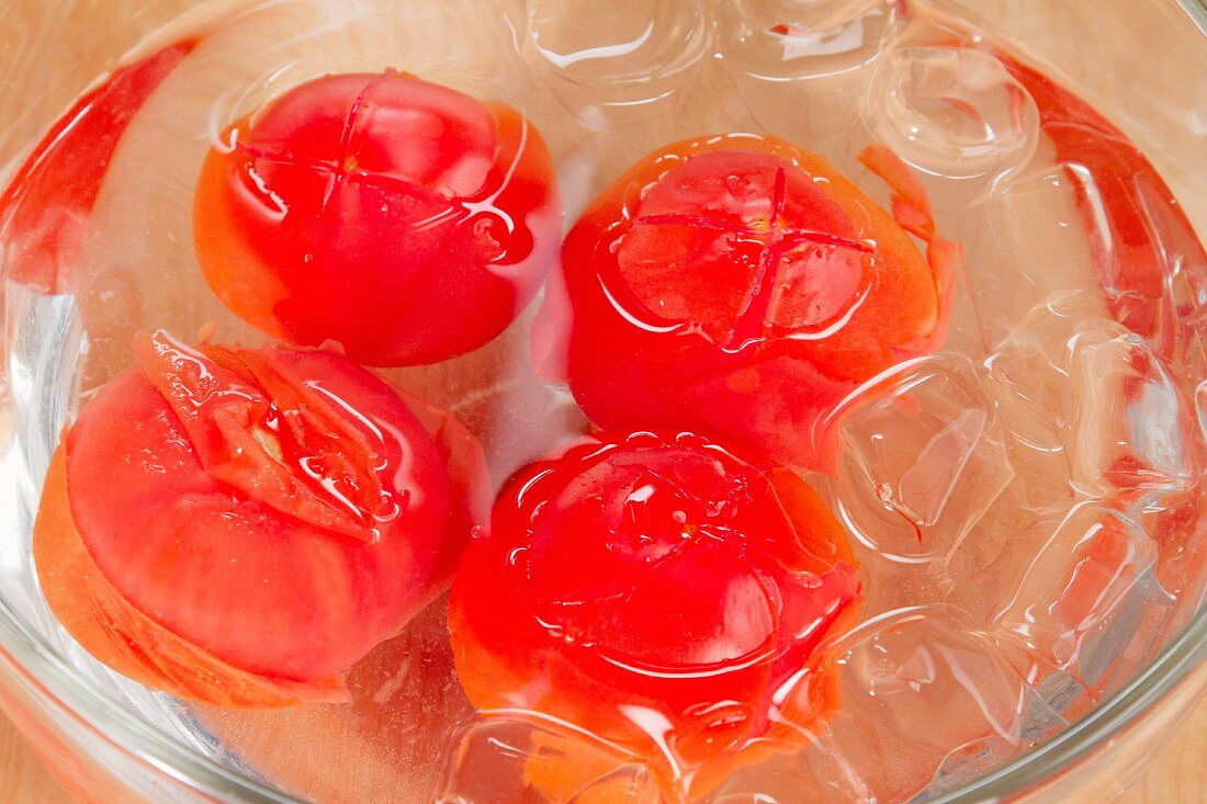 Tomatoes being quenched in iced water