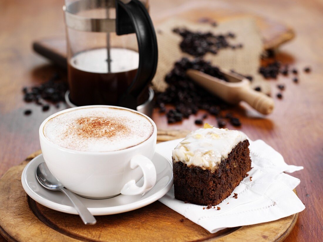 Coffee with foam and a piece of cake