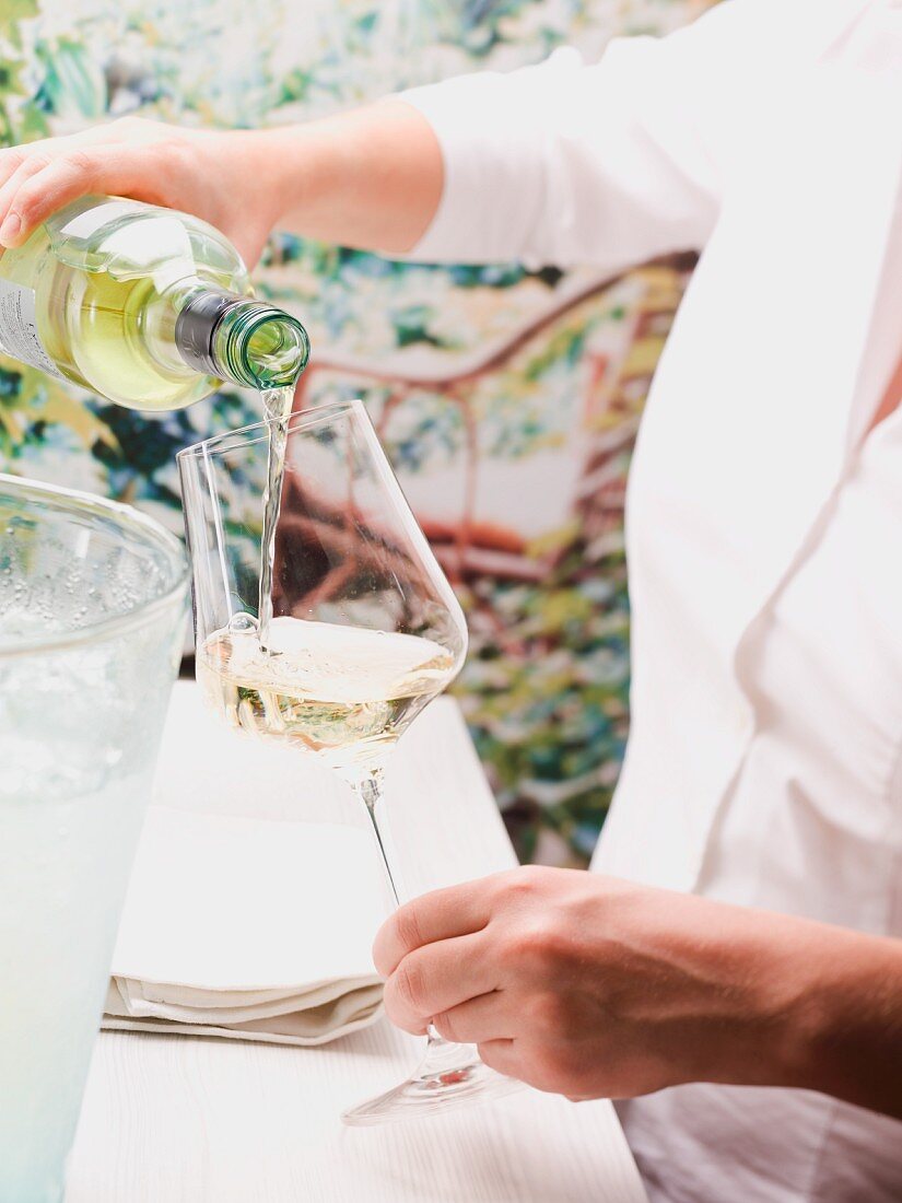 Pouring a glass of white wine