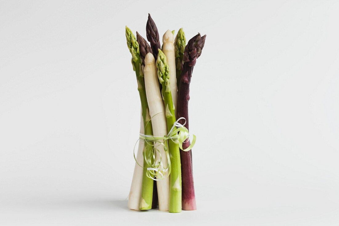 A bunch of green, white and purple asparagus