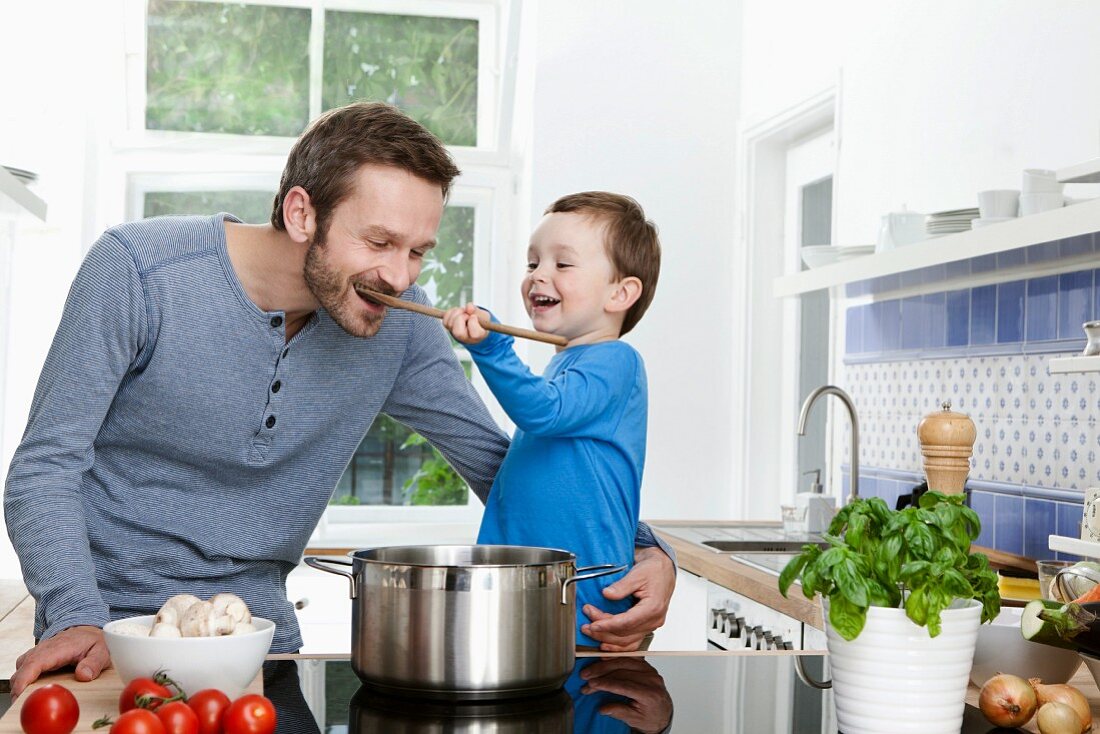 A father and son tasting food