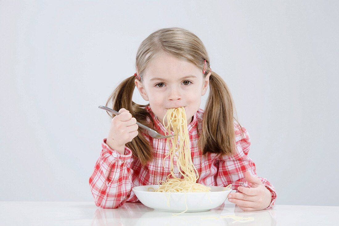 Girl eating spaghetti