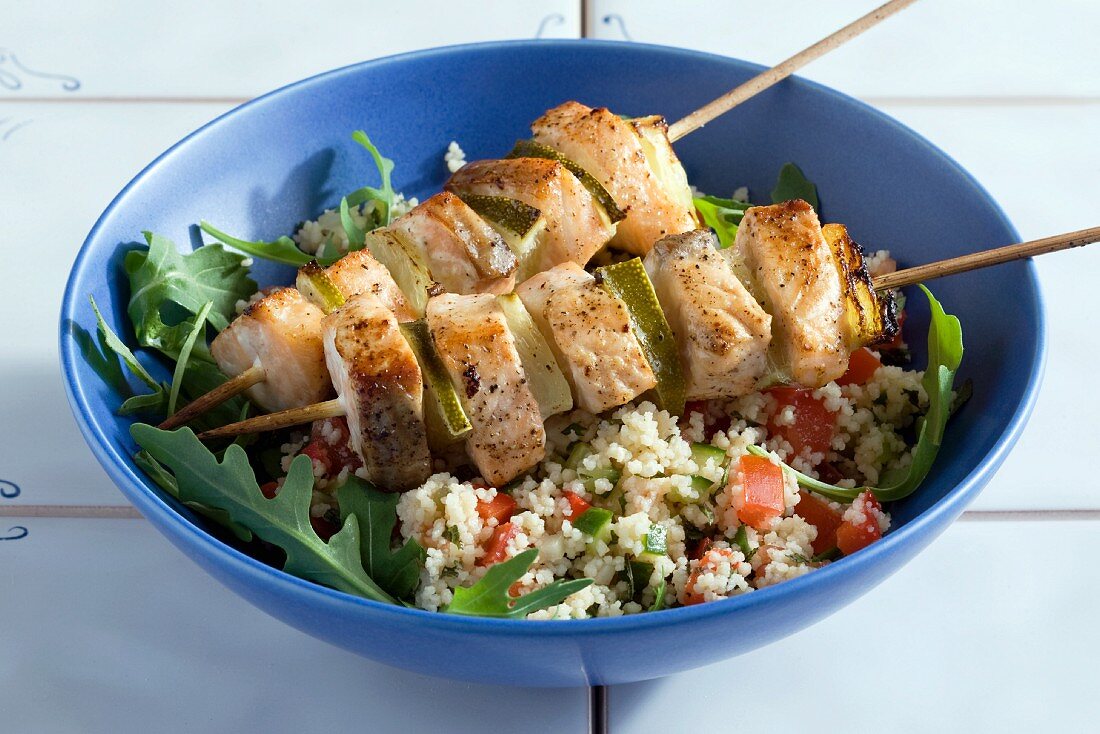 Salmon kebabs on a bed of tabbouleh