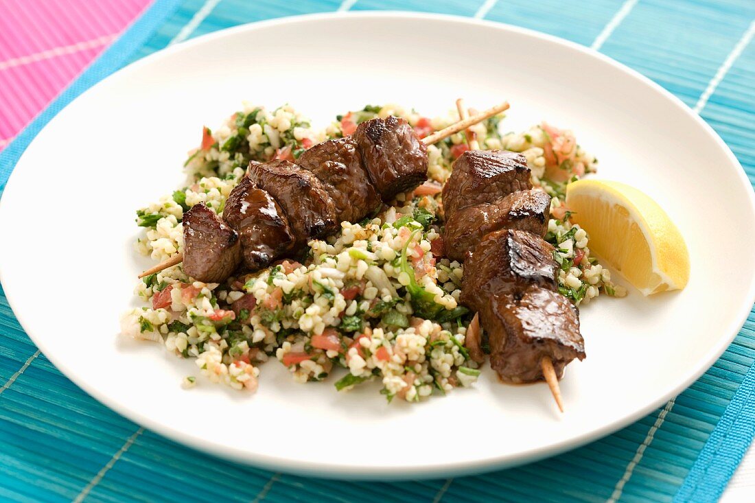 Beef kebabs on a bed of bulgur