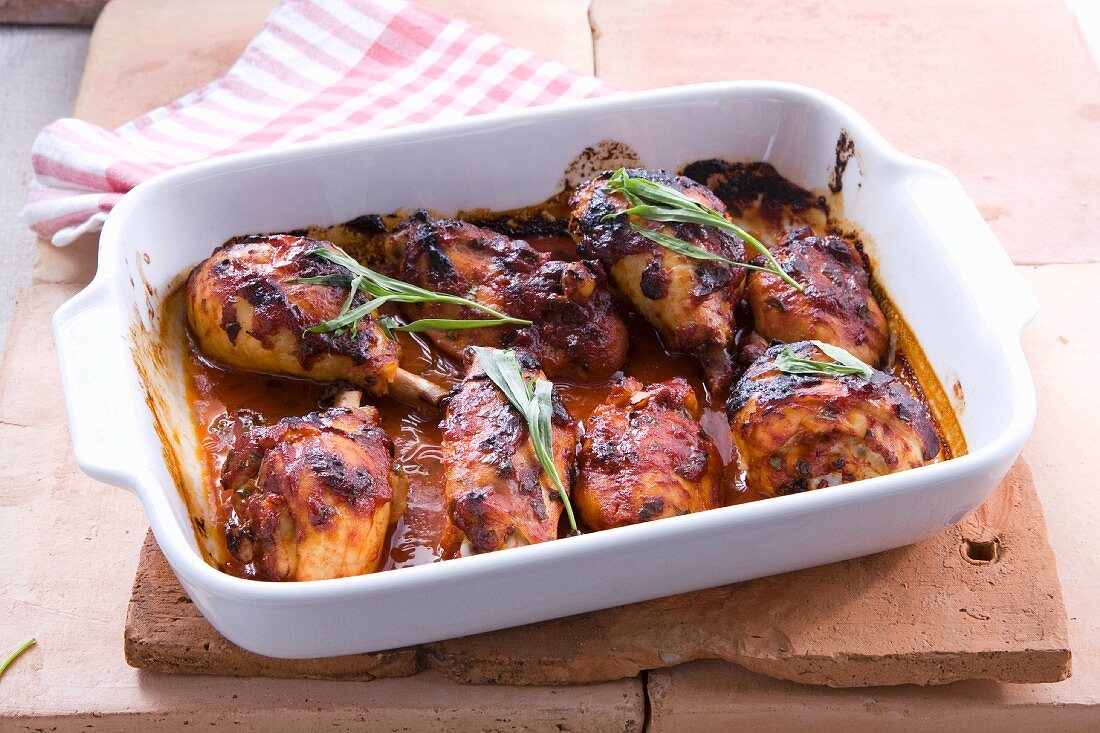 Oven-roasted chicken legs in tomato and tarragon sauce