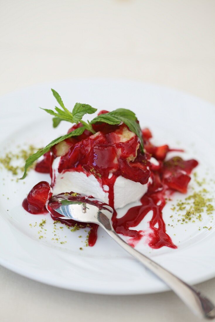 Single Scoop of Vanilla Ice Cream with Strawberry Sauce; In Bowl with Spoon