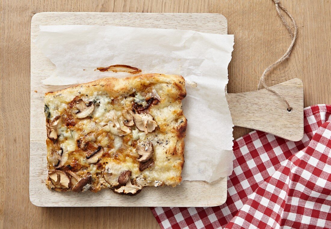 A slice of mushroom and cheese pizza