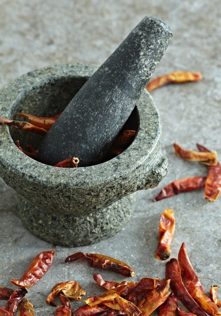 Dried chilli peppers in a mortar