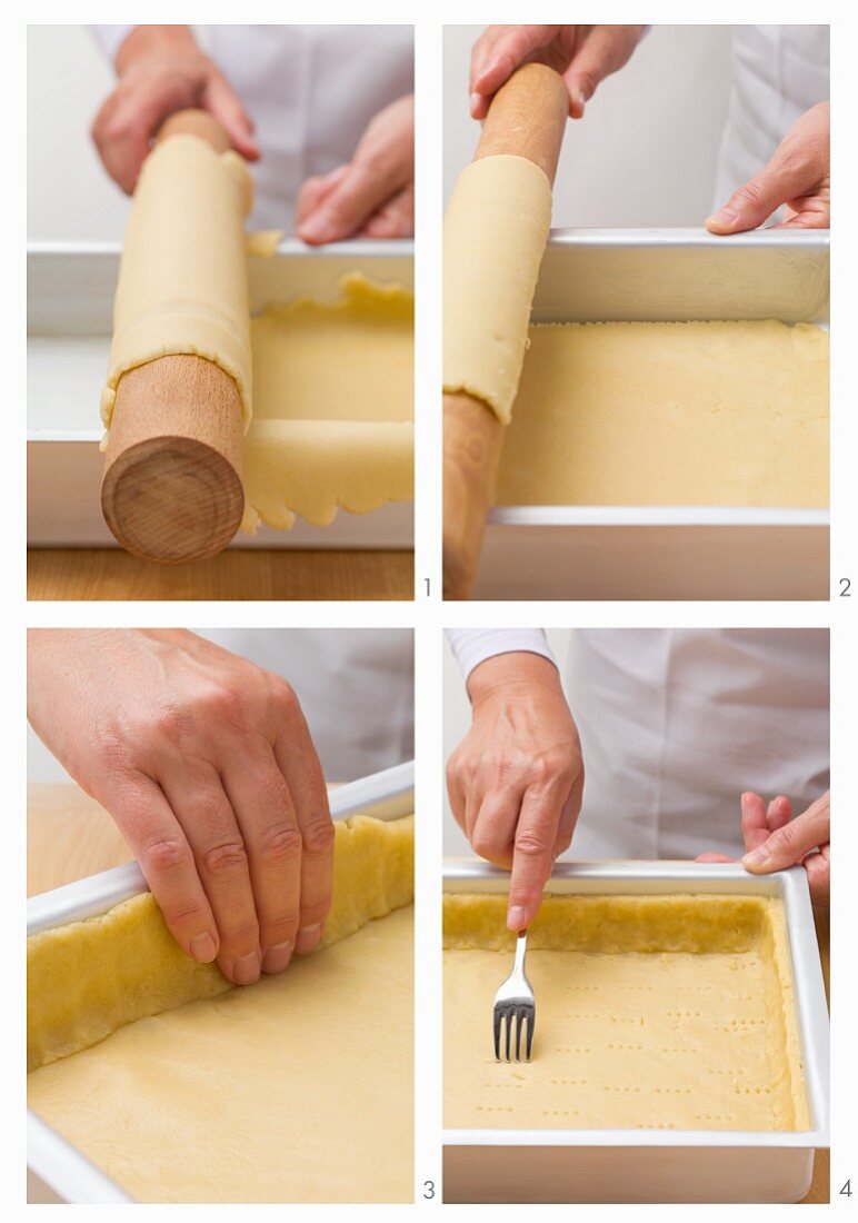 Shortbread being placed in a rectangular dish