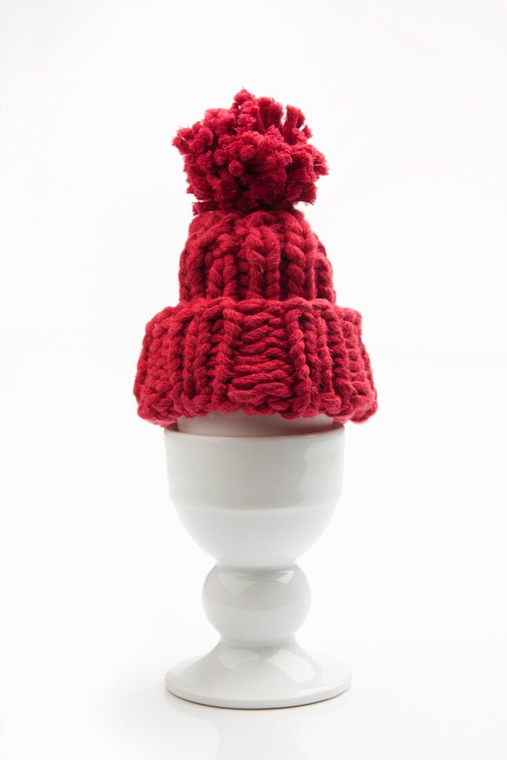 Eggcup with egg and egg cosy