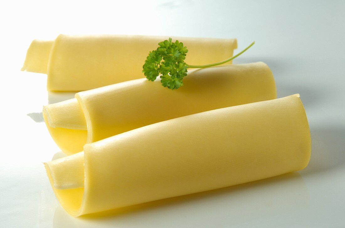 Three rolls of cheese with a parsley leaf