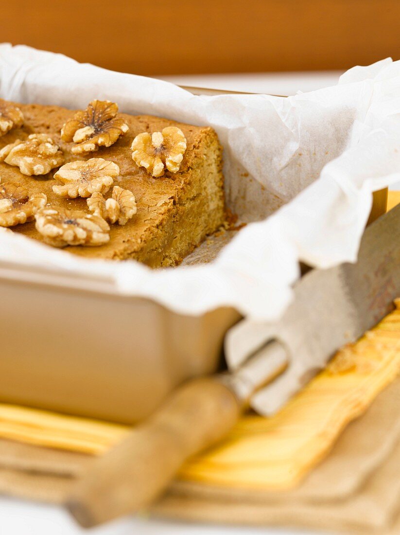 Walnut Blondies in a Parchment Lined Baking Pan; End Sliced Off