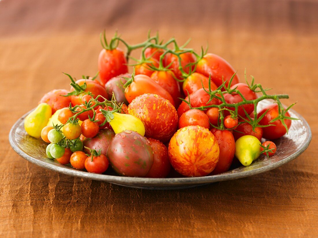 A Variety of Freshly Washed Heirloom Tomatoes on a Large Plate