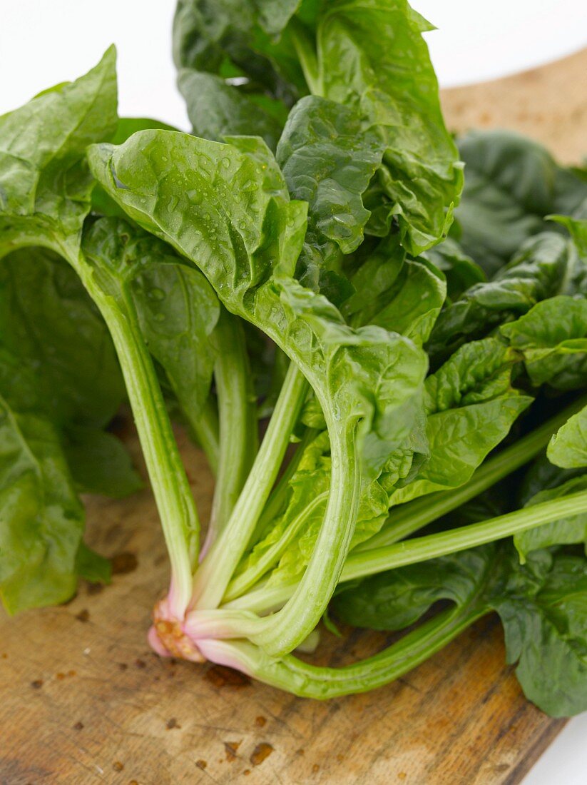 Fresh Spinach Bunch on a Cutting Board